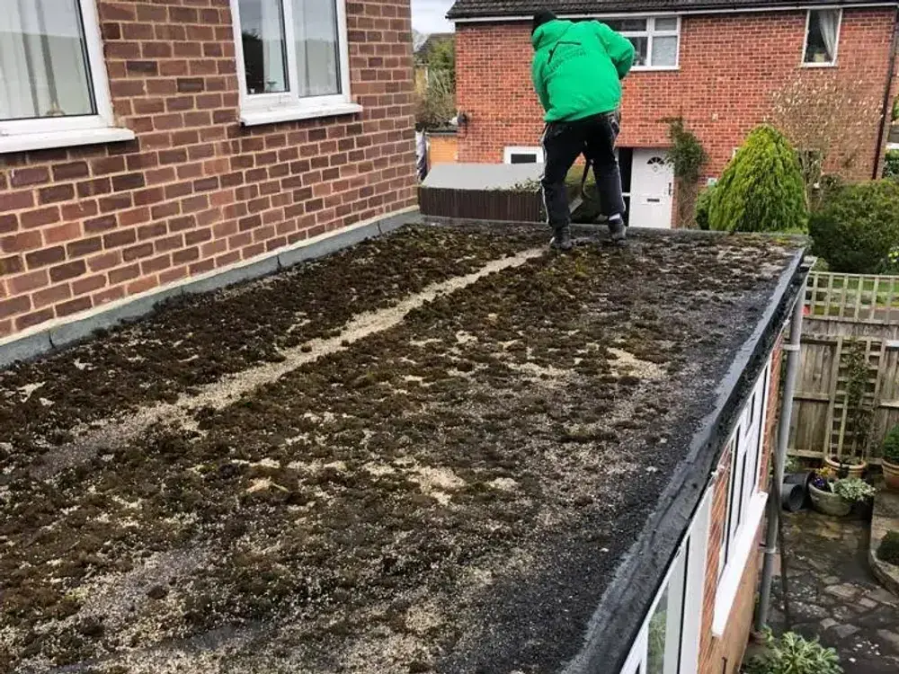 Flat extension roof covered in moss and standing water before A-List Roofing replaced it