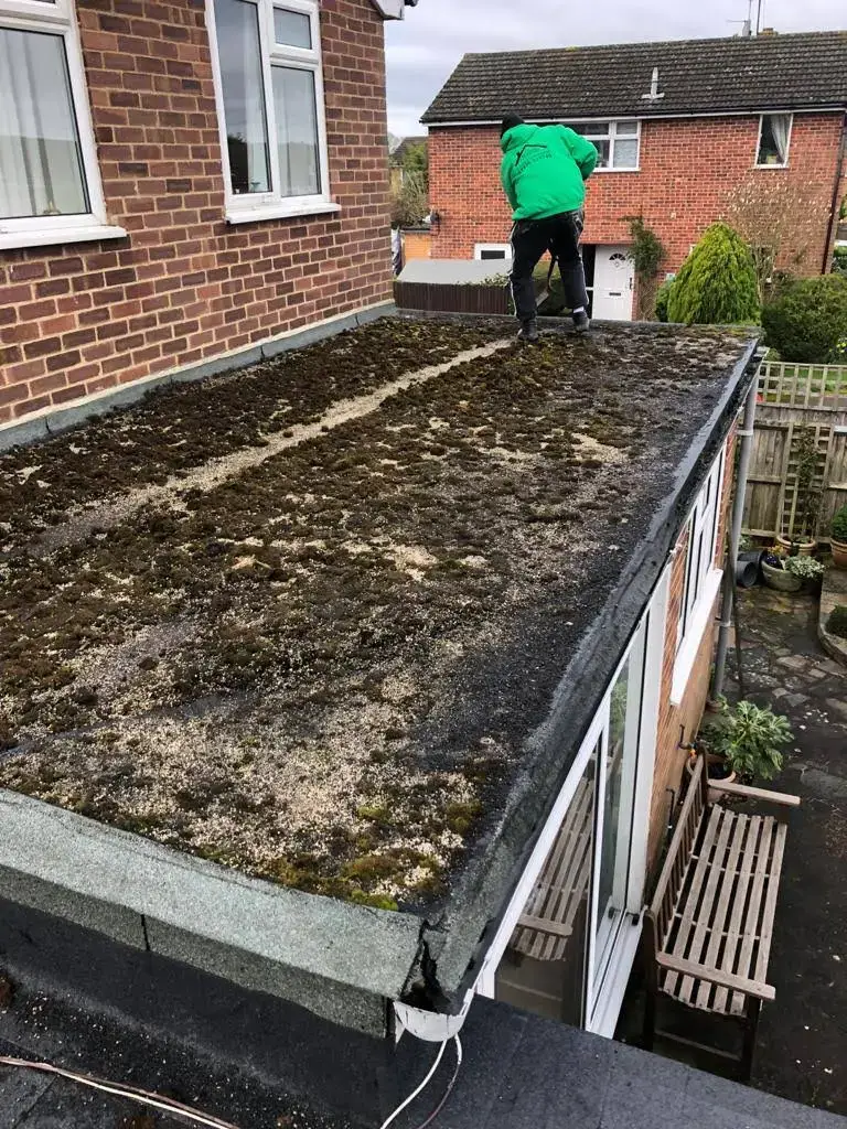 Flat roof replacement by A-List Roofing — the old roof coming off
