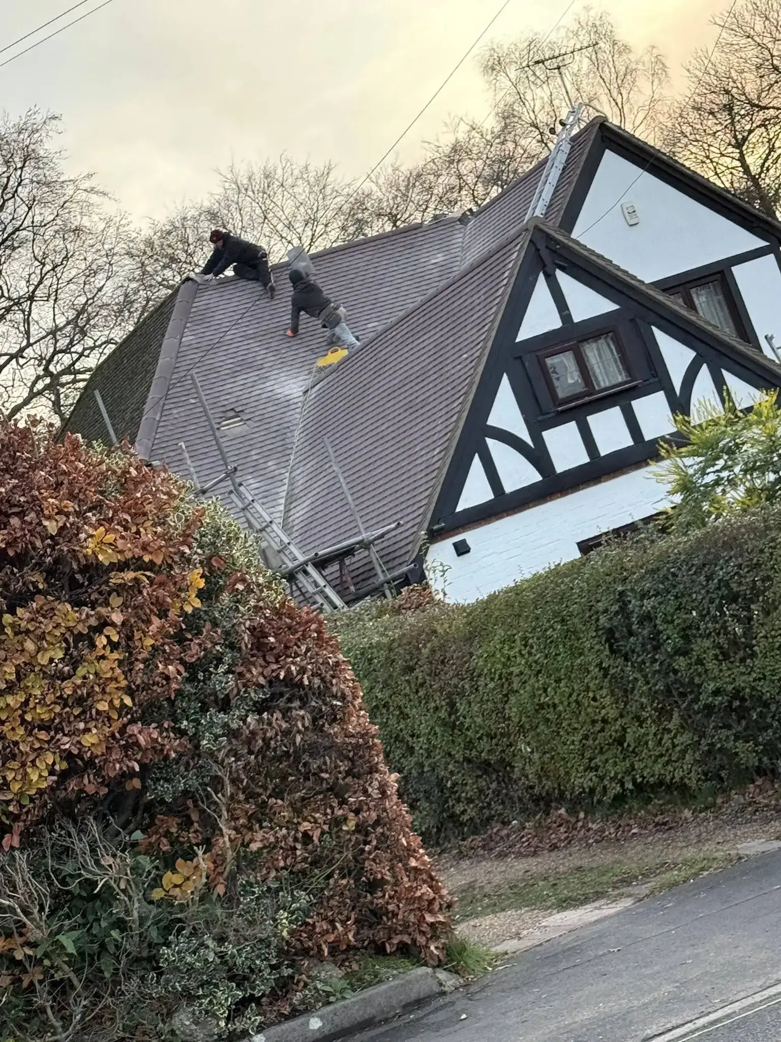Ridge repair on a tiled roof by A-List Roofing — in progress